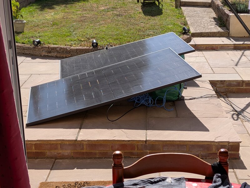 Two solar panels laid out on the patio